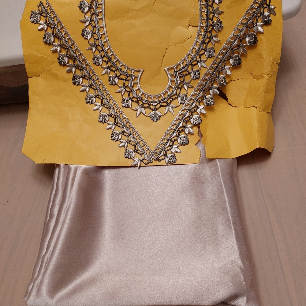 Brand new satin fabric with a beautiful embroidered neckline piece
